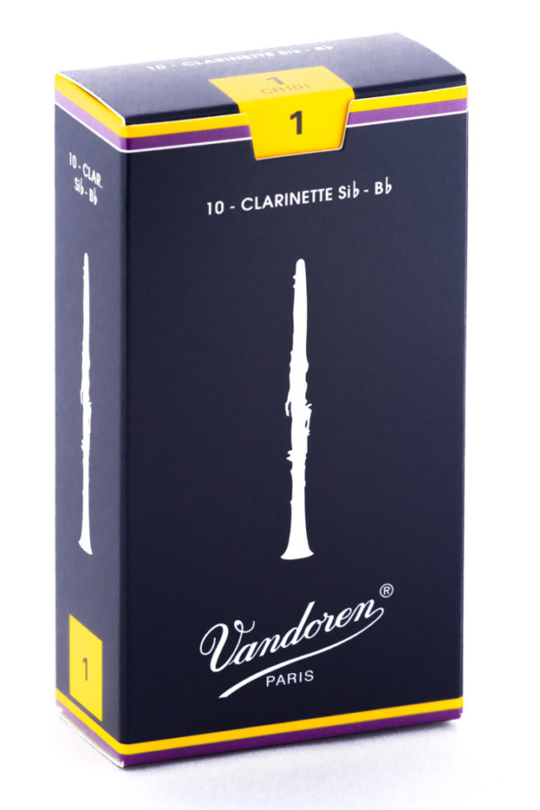 Eine dunkelblau-lila-gelbe Schachtel der Marke Vandoren mit der Aufschrift "10 CLARINETTE Sib - Bb" und einer stilisierten Abbildung einer Klarinette ist vor einem weißen Hintergrund zu sehen.