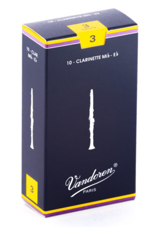 Eine dunkelblaue, quaderförmige Schachtel, umrandet von gelben Linien, zeigt Abbildungen einer Klarinette und den Schriftzug Vandoren Paris, sowie die Ziffer 3 in einem gelben Feld.