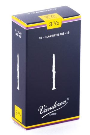 Ein dunkelblau-gelber Karton mit der Aufschrift "Vandoren Paris" und der Bezeichnung "10 - Clarinette Mib-Eb" ist vor einem weißen Hintergrund zu sehen.