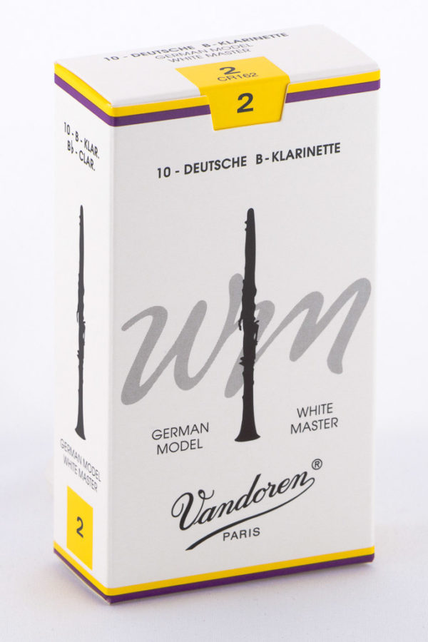 Eine rechteckige, weiße Schachtel mit gelben Akzenten zeigt eine stilisierte, schwarze Klarinette und den Schriftzug "Vandoren Paris".