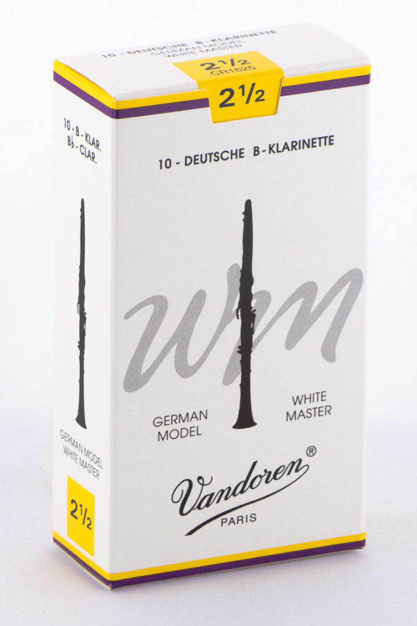 Ein weißer Karton mit gelbem und lila Akzenten zeigt eine Abbildung einer schwarzen Klarinette und den Schriftzug "Vandoren PARIS" sowie weitere Informationen wie "10-DEUTSCHE B-KLARINETTE" und "2½".