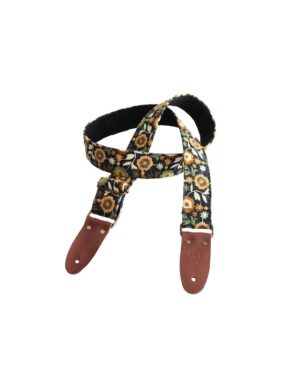 Ein Bourbon Jeans Gitarrengurt mit Blumenmuster und braunen Lederenden liegt auf einem weißen Hintergrund.