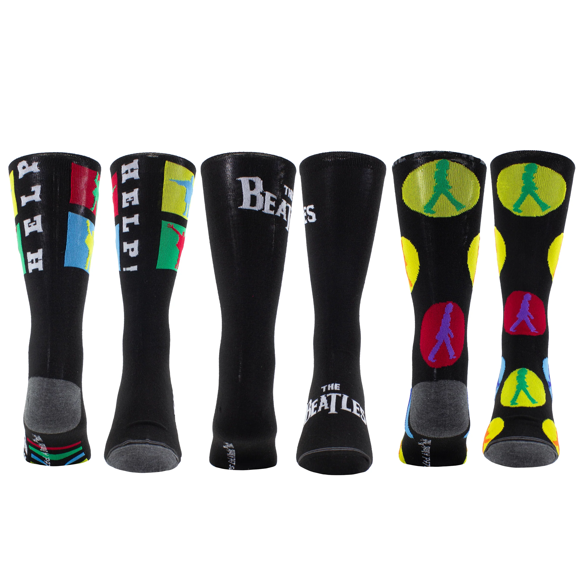 Das Bild zeigt sechs einzelne schwarze Sockenmodelle mit unterschiedlichen Beatles-Motiven wie dem Albumcover "Help!", dem Bandnamen und den berühmten Silhouetten, teils mit farbigen Elementen.
