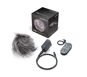 Das Bild zeigt ein Zoom H6 Accessory Pack mit einer Produktverpackung, einem grauen Fell-Windschutz, einem grauen Adapter mit Kabel und einer grauen Fernbedienung.