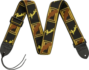 Der Gitarrengurt "Fender Monogrammed Strap 2" ist schwarz mit gelben Fender-Logos und braunen Umrissen, sowie einer schwarzen Schnalle und Lederenden.
