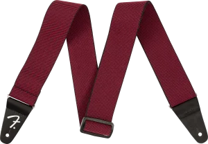 Das Bild zeigt einen Fender WeighLess RED TWEED Strap 2" Gitarrengurt mit einem roten, tweedartigen Gurtband und schwarzen Endstücken, auf denen das Fender-Logo zu sehen ist.